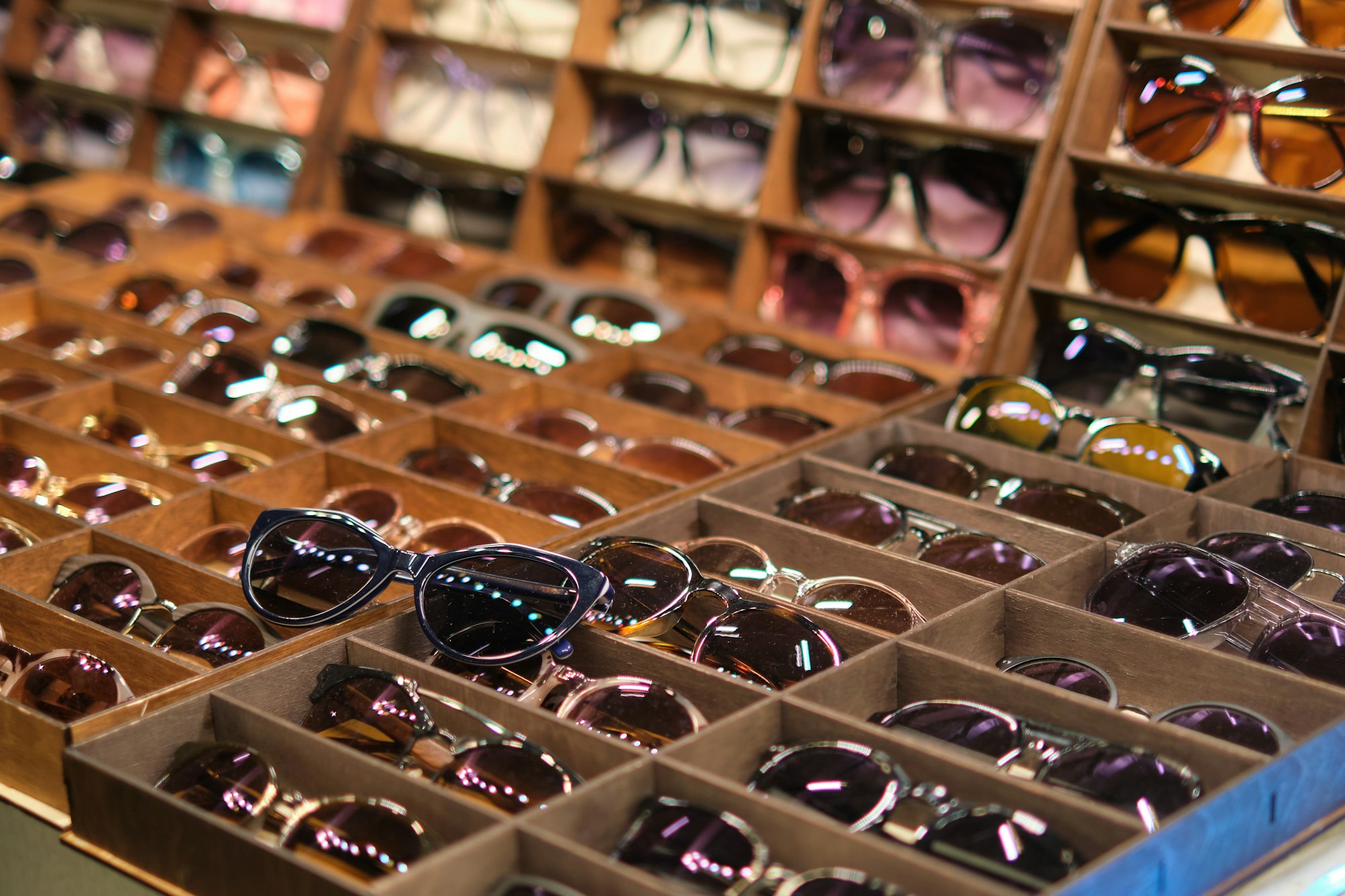 market stall filled with a diverse selection of sunglasses, showcasing affordable eyewear options